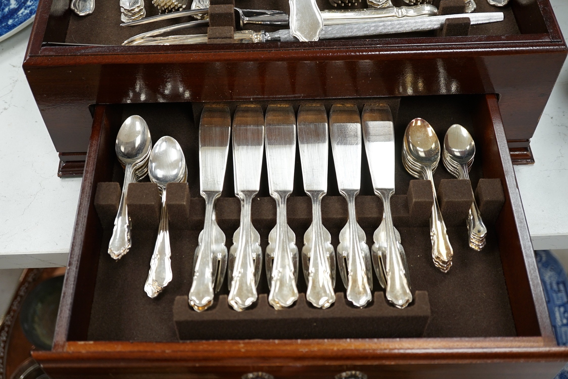 A silver plated two tier canteen of cutlery